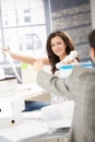 Joyous female passing phone to colleague in office Royalty Free Stock Photo