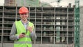 Cheerful construction supervisor posing for camera against new building Royalty Free Stock Photo