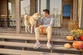 Joyous guy spending time with his favorite pet outdoors Royalty Free Stock Photo