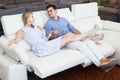 Joyous man and woman are choosing of sofa-transformer in furniture store