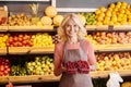 joyous mature saleswoman holding two packs