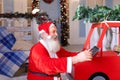 Joyous Santa Claus enjoying with modern gadget.