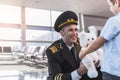 Joyous smiling aviator giving toy to boy Royalty Free Stock Photo