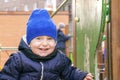 Joyous smiling kid having funny time on playground