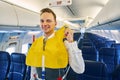 Joyous steward wearing a life vest aboard the aircraft