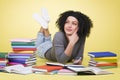 Joyous student girl reading surrounded by colorful books. Royalty Free Stock Photo