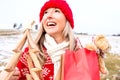 Joyous woman holding small wooden Christmas tree and gift bags