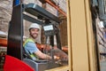 Joyous young lift truck operator at work