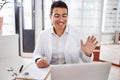 Joyous young ophthalmologist greeting his female client Royalty Free Stock Photo