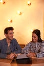 Joyously smiling young couple in restaurant