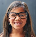 The joys of being a kid. Studio portrait of a little girl wearing spectacles against a dark background. Royalty Free Stock Photo