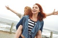 The joys of motherhood. a mother giving her daughter a piggyback ride. Royalty Free Stock Photo