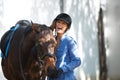 The joys of owning a horse. A beautiful woman laughing outside while standing outside with her horse. Royalty Free Stock Photo