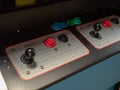 Joystick and button controls of classic arcade cabinet in dark arcade Royalty Free Stock Photo