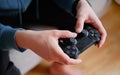 Joystick for game console in the mans hands.The concept of leisure and entertainment Royalty Free Stock Photo