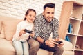 Man in Plaid Shirt Sitting on Sofa with Joystick in Hands Royalty Free Stock Photo