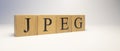 jpeg word created from wooden cubes. technology and the internet.