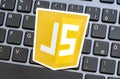 JS, JavaScript programming language logo laying on a modern computer keyboard, nobody. Web development, browser scripts, web page