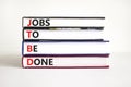 JTBD jobs to be done symbol. Concept words JTBD jobs to be done on books on beautiful white background. Business and JTBD jobs to