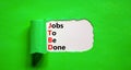 JTBD jobs to be done symbol. Concept words JTBD jobs to be done on white paper on a beautiful green background. Business and JTBD