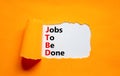 JTBD jobs to be done symbol. Concept words JTBD jobs to be done on white paper on a beautiful orange background. Business and JTBD