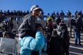 Venezuelan man carrying his son after evicted from camp in Juarez