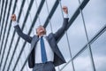 Jubilant business man on the background of an office building