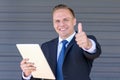 Jubilant businessman giving a thumbs up