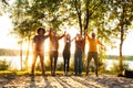 Jubilant Lakeside Victory: Friends Celebrating in the Sunset