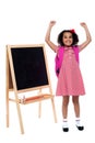 Jubilant little girl in school uniform Royalty Free Stock Photo