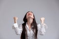 Jubilant woman laughing and clenching her fists