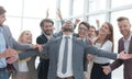 Jubilant young businessman accepting the congratulations of his business team. Royalty Free Stock Photo