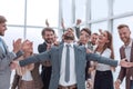 Jubilant young businessman accepting the congratulations of his business team. Royalty Free Stock Photo