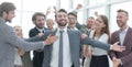 Jubilant young businessman accepting the congratulations of his business team. Royalty Free Stock Photo