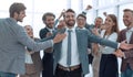 jubilant young businessman accepting the congratulations of his business team. Royalty Free Stock Photo