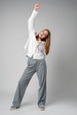 Jubilant Young Woman Celebrating a Victory With a Raised Fist in Studio