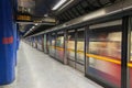 Jubilee line train leaves modern North Greenwich station