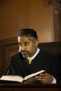 Judge With Book Looking Away In Court Room Royalty Free Stock Photo