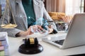 Judge in a courtroom using laptop and tablet with AML anti money laundering icon on virtual screen Royalty Free Stock Photo