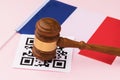 Judge gavel, barcode sheet and flag of France, the concept of administrative punishment for violation of the regime using QR codes Royalty Free Stock Photo