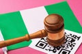 Judge gavel, barcode sheet and flag, concept of administrative punishment for violation of the regime using QR codes in Nigeria Royalty Free Stock Photo