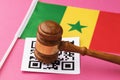 Judge gavel, barcode sheet and Senegalese flag, concept of administrative punishment for violation of the regime using QR codes Royalty Free Stock Photo