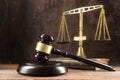 Judge gavel, book and scales on the wooden lawyers desk, justice Royalty Free Stock Photo