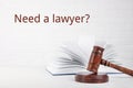 Judge gavel, book and text NEED A LAWYER? on background Royalty Free Stock Photo