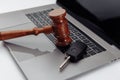 Judge gavel and car keys on laptop computer keyboard. Symbol of law, justice and online car auction Royalty Free Stock Photo