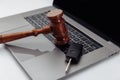 Judge gavel and car keys on laptop computer keyboard. Symbol of law, justice and online car auction. Royalty Free Stock Photo