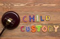 Judge gavel and colourful letters regarding child custody, family law concept.