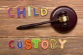 Judge gavel and colourful letters regarding child custody, family law concept.