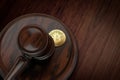 Judge gavel crushing Bitcoin. Bitcoin traders law problems