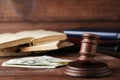 Judge gavel with dollars and books Royalty Free Stock Photo